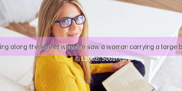 A man was walking along the street when he saw a woman carrying a large box. It was half i